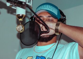 Rapper in the studio making a new song for his album. This is a typical night for a hip-hop artist, living the lifestyle and trying to achieve his dreams.