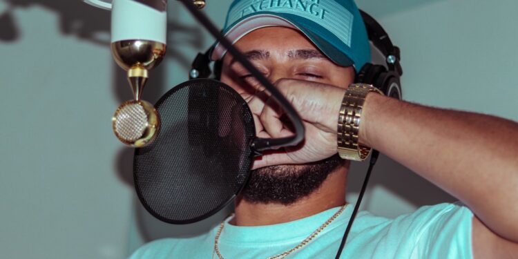 Rapper in the studio making a new song for his album. This is a typical night for a hip-hop artist, living the lifestyle and trying to achieve his dreams.