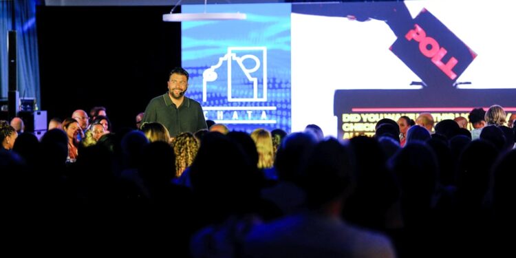 Marketing keynote speaker delivering a high-impact presentation at a business conference. The event highlights innovation, audience engagement, and modern brand strategy.