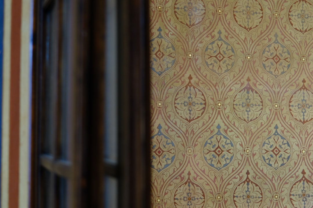 Vintage patterned wallpaper with a wooden frame.
