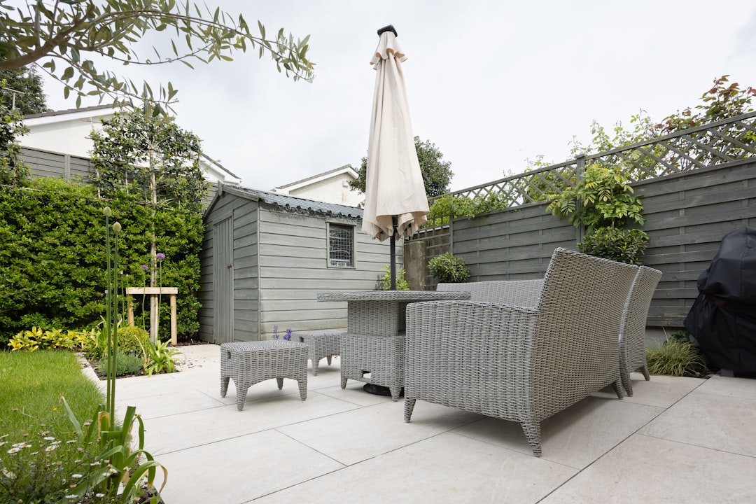 A patio with a table and chairs and an umbrella