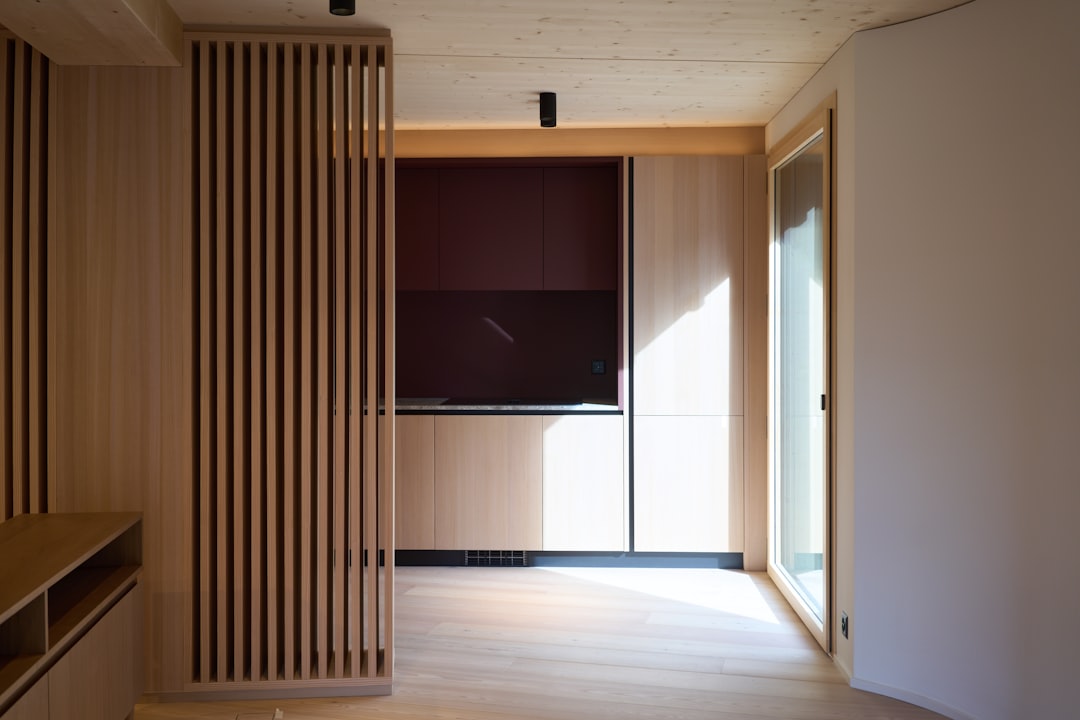 A room with a TV and a large window