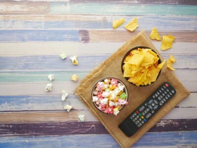 black remote control beside brown wooden chopping board